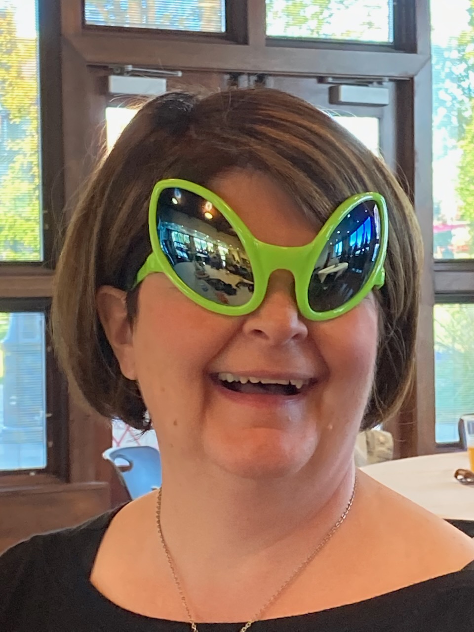 Pam with a weird pair of sunglasses in the shape of alien eyes